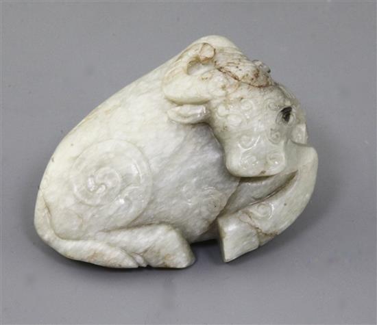 A Chinese pale celadon jade figure of a recumbent buffalo, Ming dynasty, length 11cm